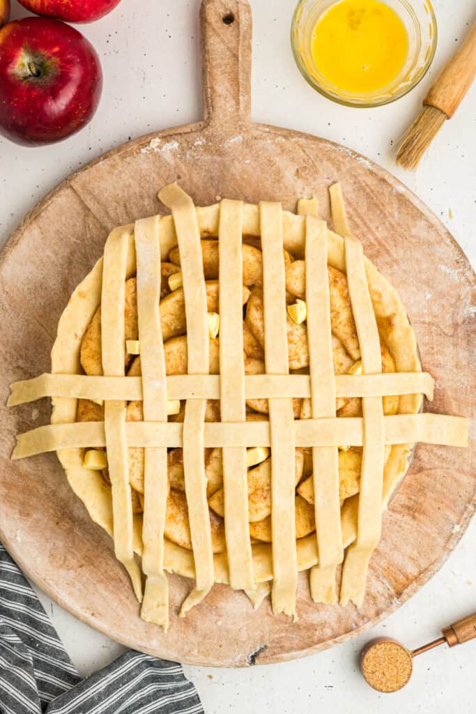 Top-down view of pie with woven lattice crust ready for baking.