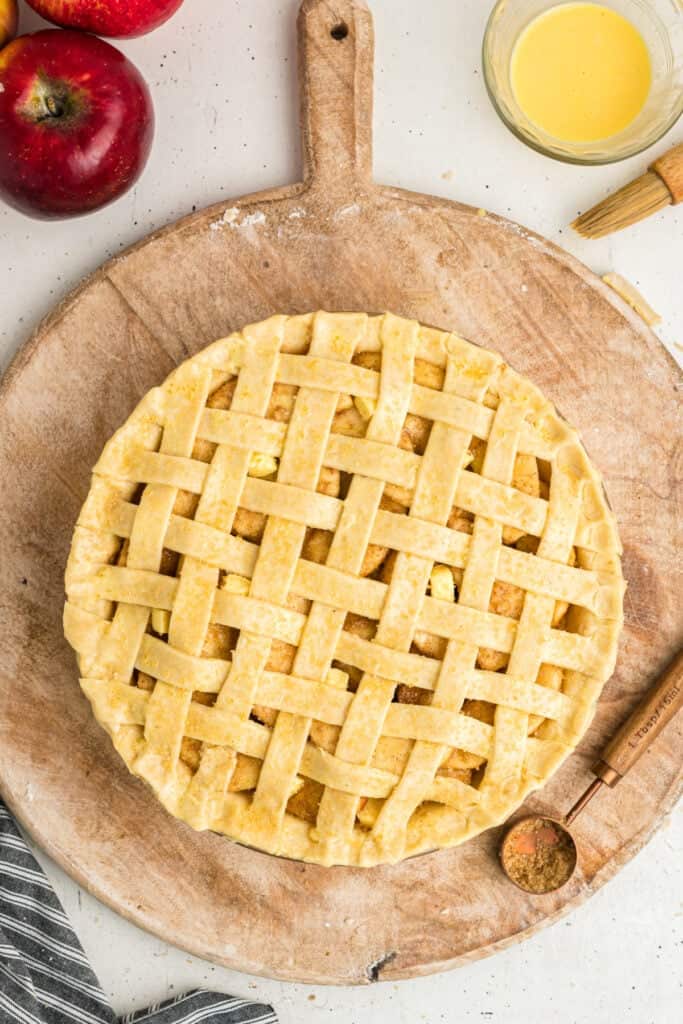 Unbaked lattice crust apple pie sprinkled with coarse sugar, ready for the oven.