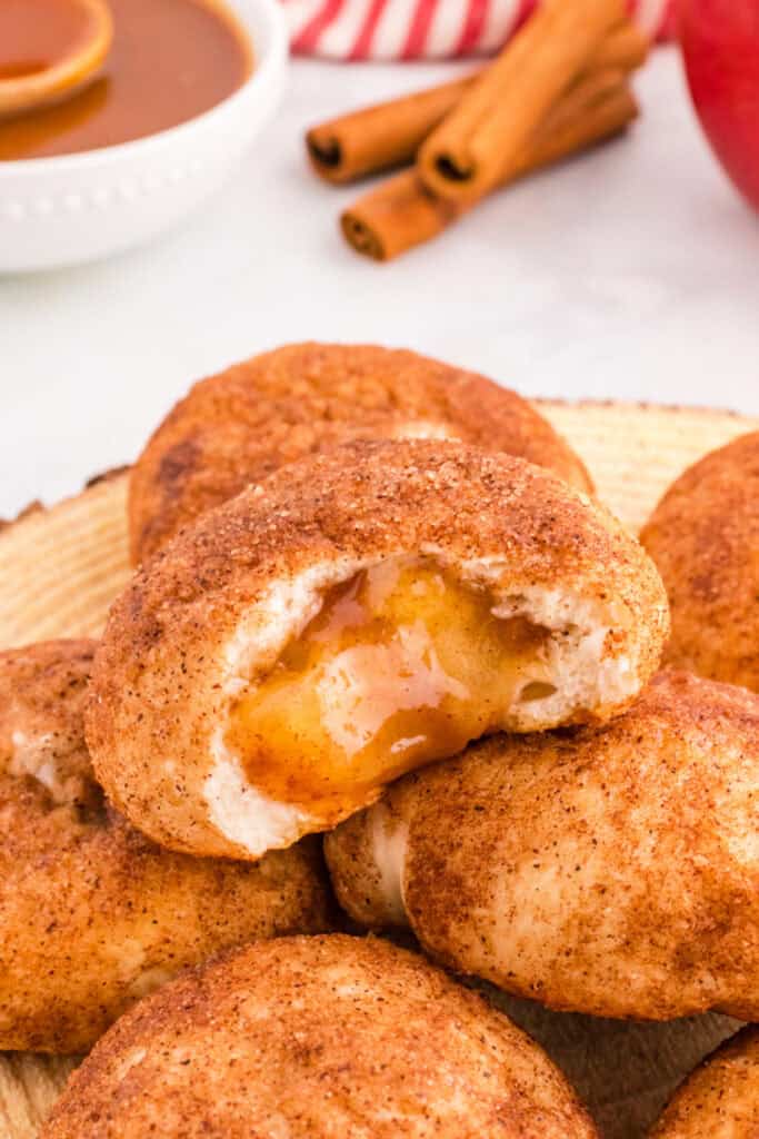 Close-up of baked apple pie bomb with gooey spiced apple filling inside.