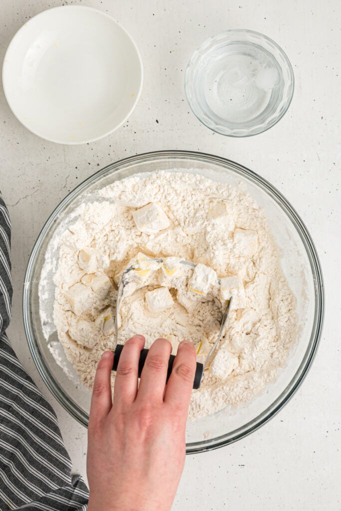 Pastry blender cutting butter into flour mixture for easy pie crust recipe