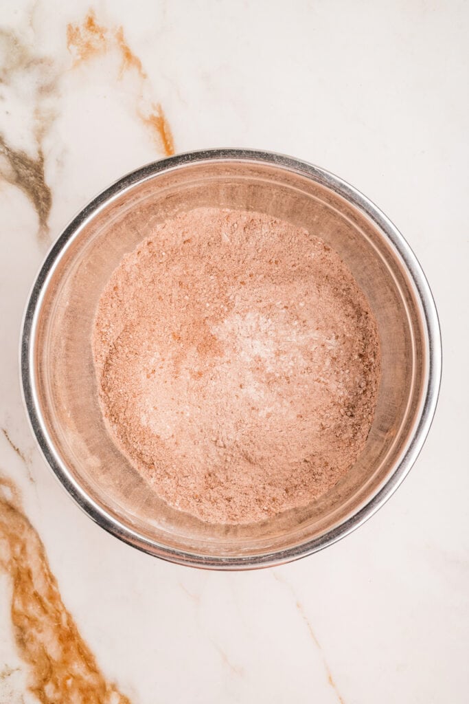 Whisked dry ingredients fully combined in a mixing bowl