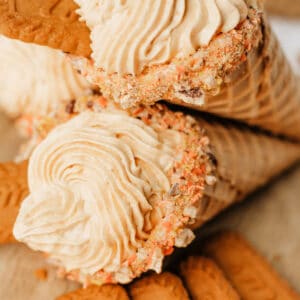 Overhead view of stacked pumpkin cheesecake cones with swirled filling and Biscoff cookies