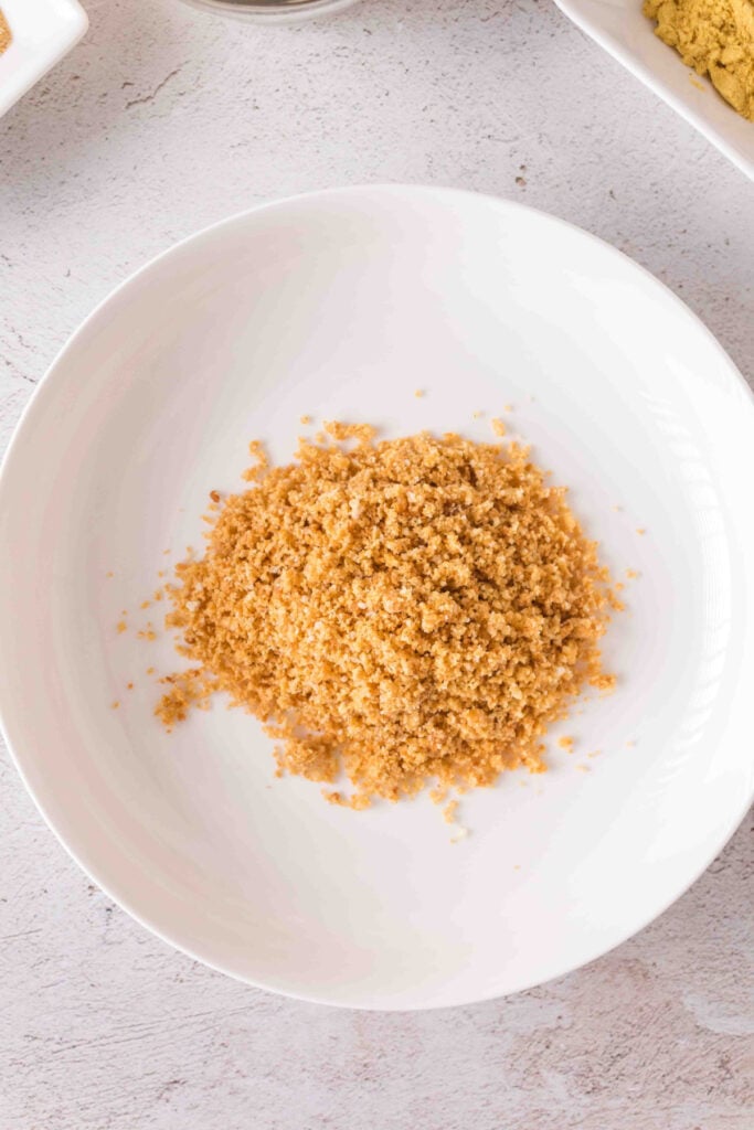Bowl of finely crushed croutons ready to use as breading for pork chops.
