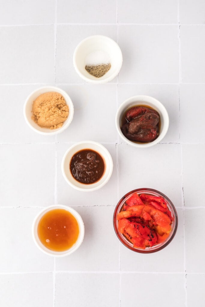 Small bowls with chipotle peppers, roasted red peppers, honey, brown sugar, chipotle sauce, salt, and pepper for the wing sauce.