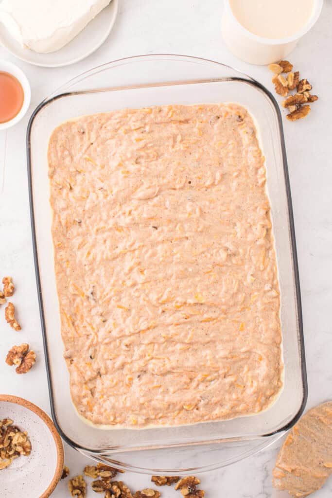 Glass baking dish filled with butternut squash cake batter before going into the oven.