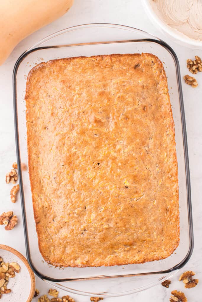 Overhead view of the baked butternut squash cake in a glass dish before frosting.