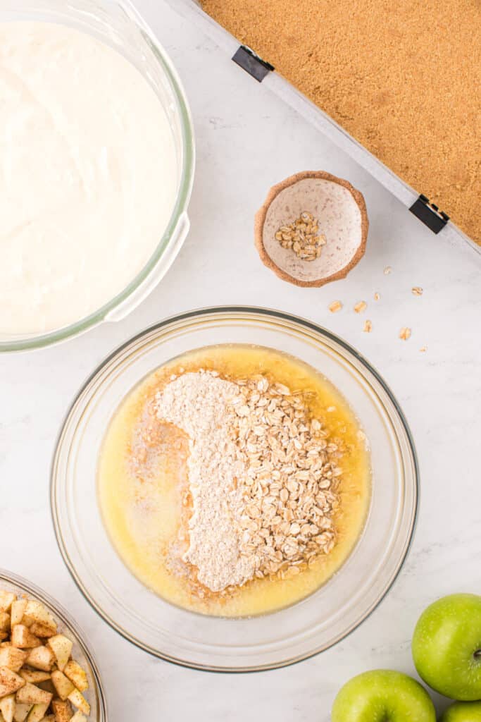 Bowl with oats, cookie mix, and melted butter being combined for the crumb topping.