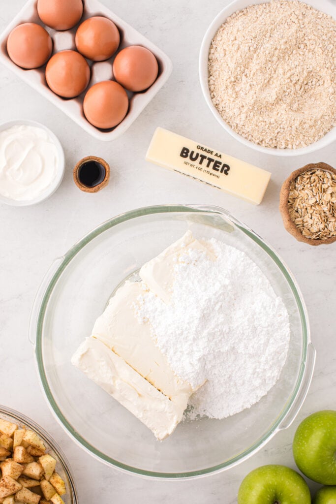 Cream cheese and powdered sugar in a large glass mixing bowl.