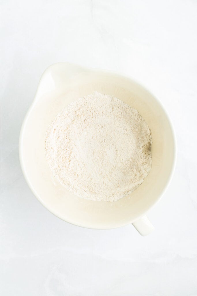 Dry ingredients whisked together in a mixing bowl for Cheddar Butter Swim Biscuits.