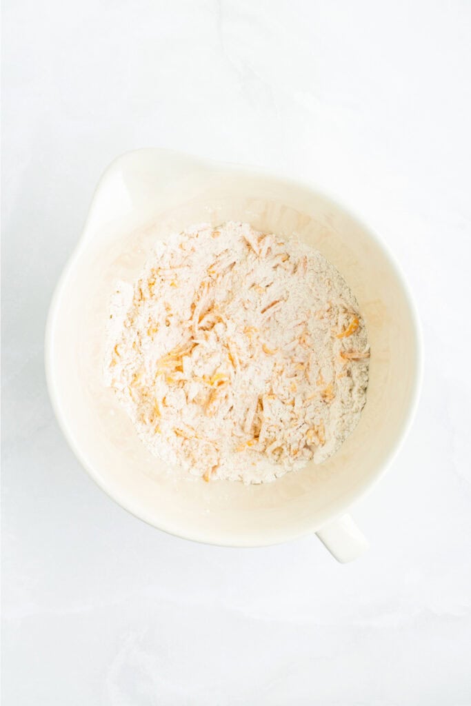 Flour mixture combined with shredded cheddar cheese before adding buttermilk.