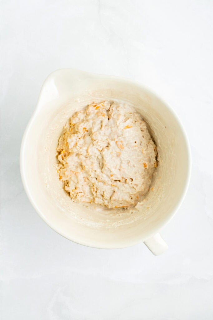 Biscuit dough mixed until just combined, showing a soft and slightly lumpy texture.