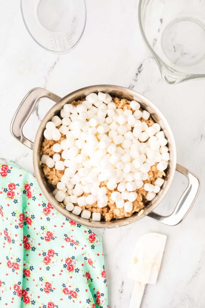 Reserved mini marshmallows added to the pot of cereal mixture for extra gooey pockets in the Browned Butter Rice Crispy Treats.