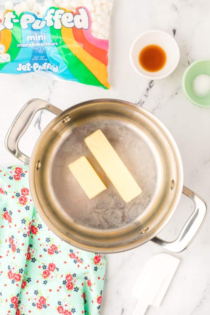 Butter sticks in a stainless steel pot on the stove, ready to be melted for Browned Butter Rice Crispy Treats.