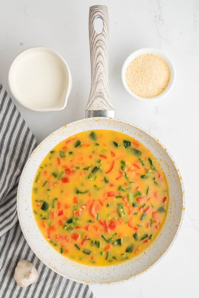 Pepper mixture simmering and thickening in the skillet.