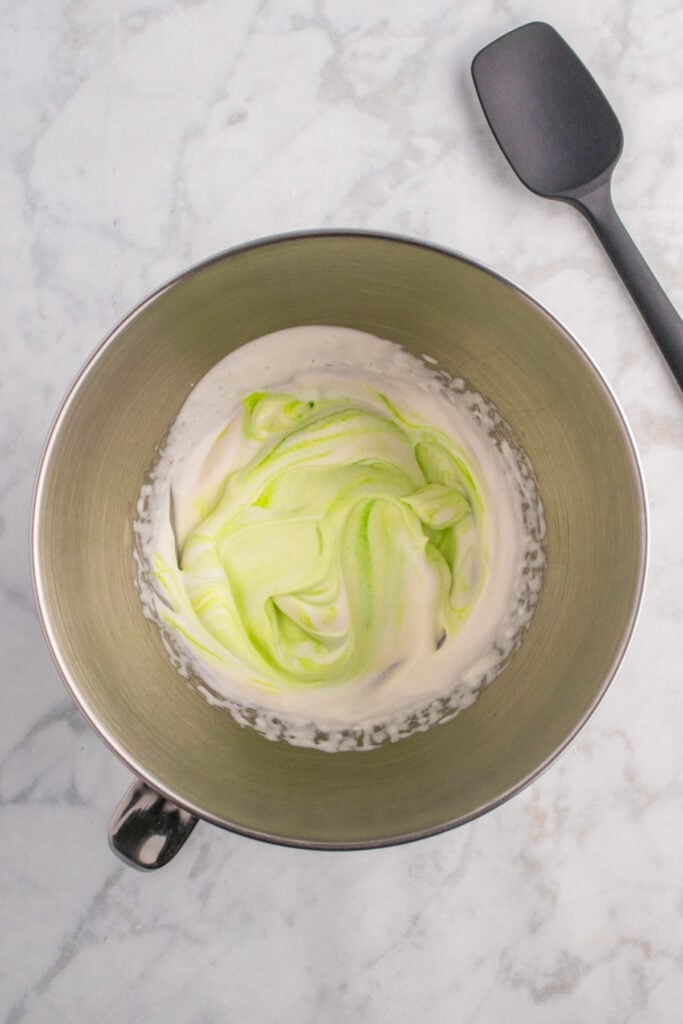 Mixing bowl with swirled green and white whipped cream to create a toxic waste foam effect.