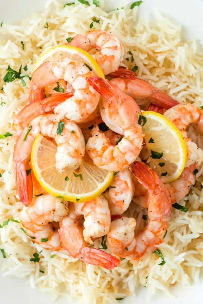 Close-up of shrimp and lemon slices over rice showing detail of texture and seasoning.