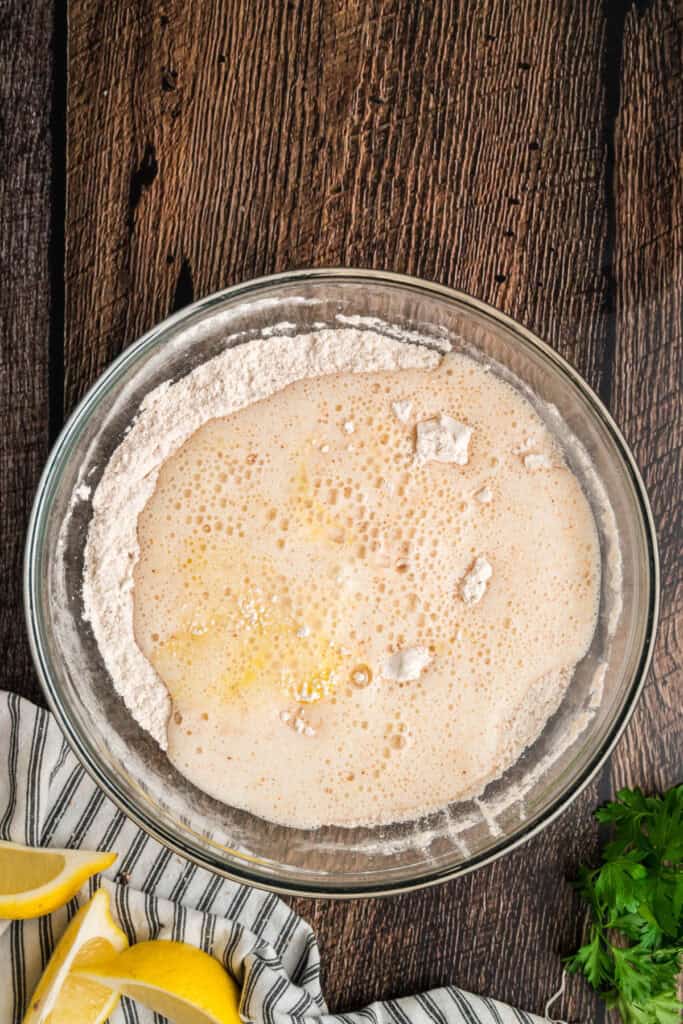 Beer and beaten egg poured into the seasoned flour to begin forming the beer batter.