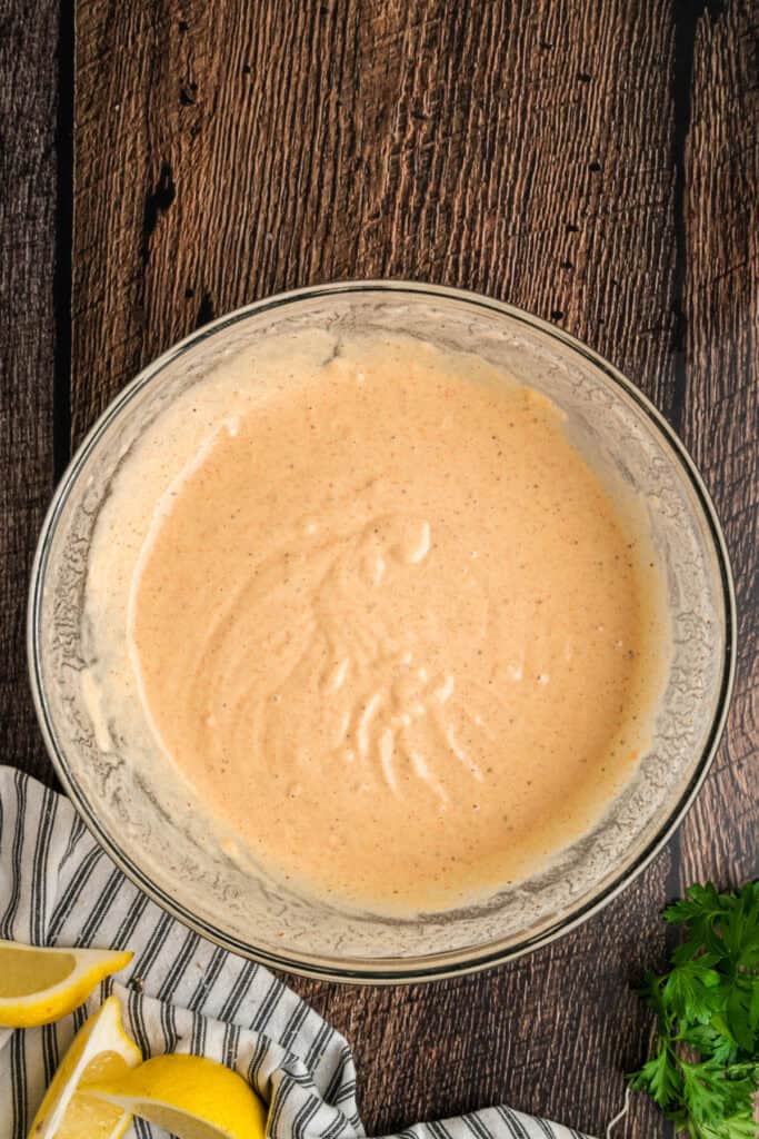 Smooth, well-mixed beer batter ready for coating cod filets before frying.