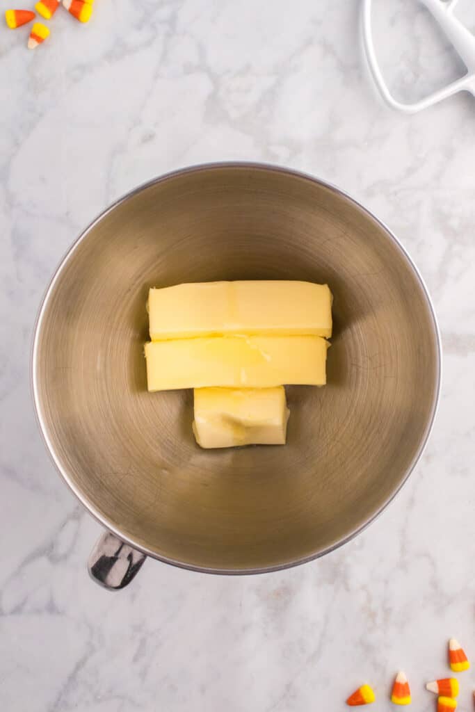 Mixing bowl with sticks of butter ready to be beaten for frosting.