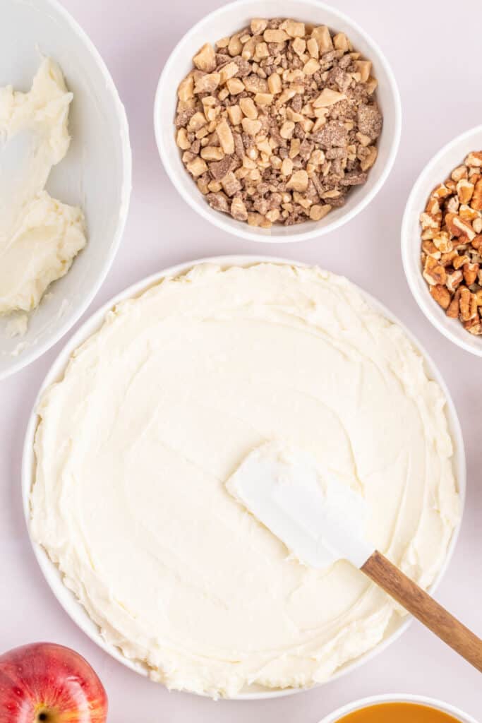 Cream cheese layer spread evenly in a serving dish using a rubber spatula.