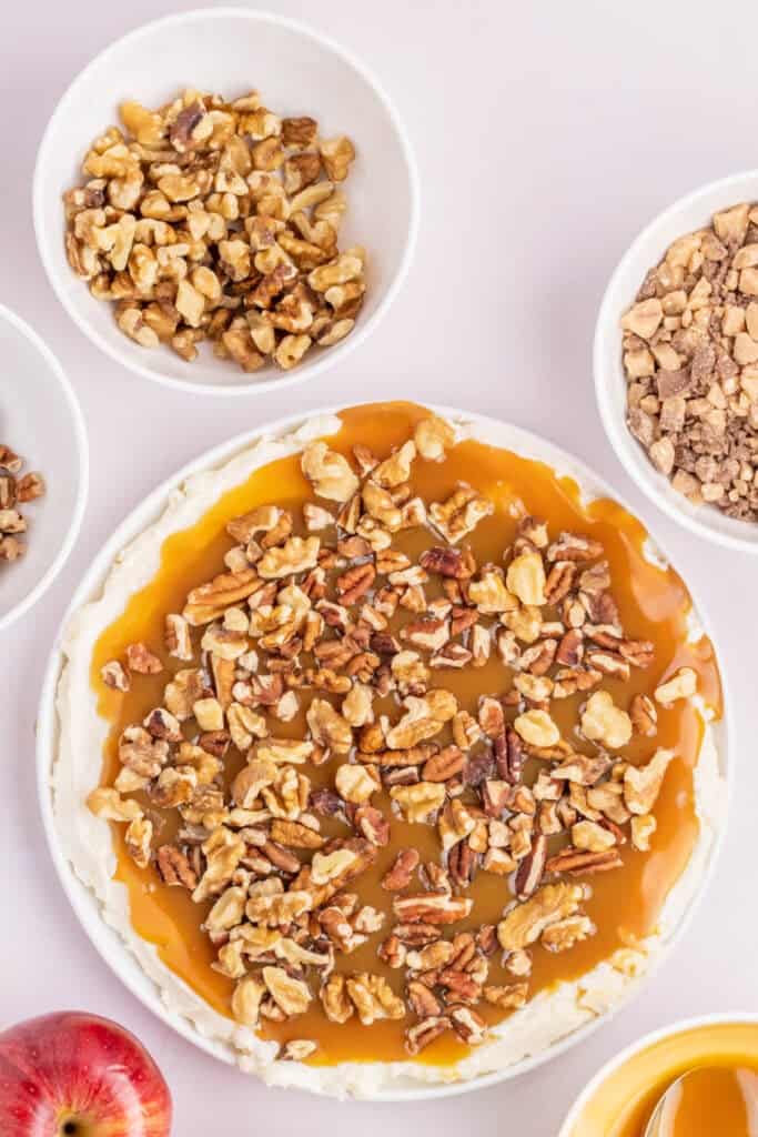 Combination of chopped walnuts and pecans layered on top of caramel.