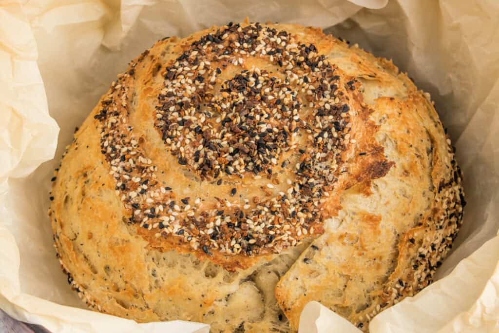 Close-up of baked everything bagel bread showing crispy crust and toasted seasoning.