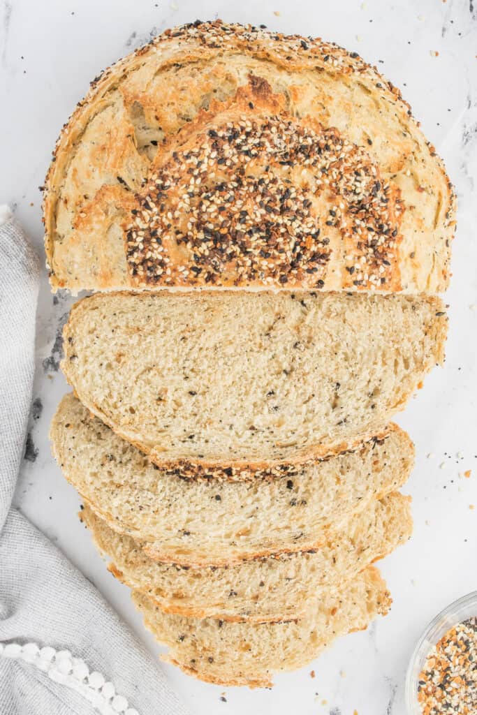 Sliced everything bagel bread showing soft interior and crisp, seasoned crust.