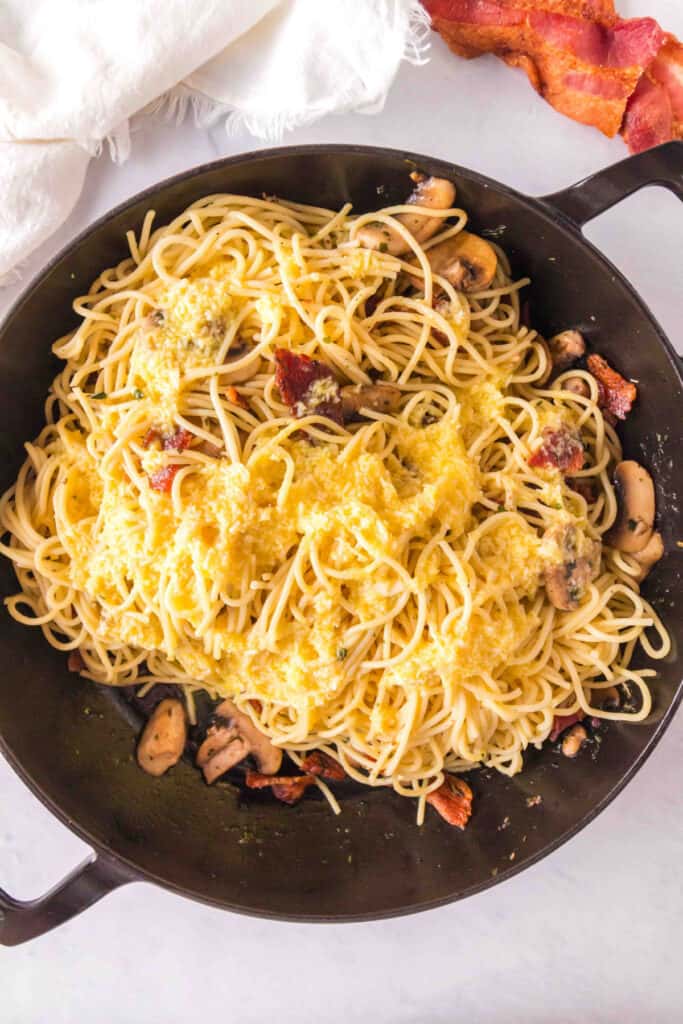 Egg and cheese mixture poured over hot spaghetti in the skillet before tossing.