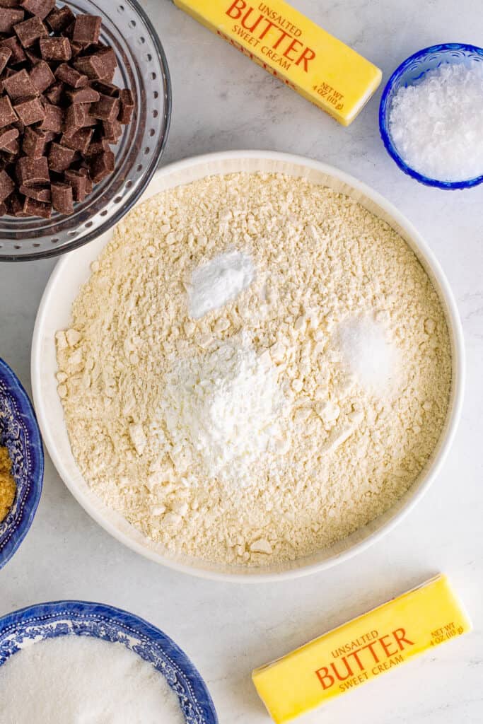 Large bowl of flour mixture with cornstarch, baking soda, and salt placed on top before mixing.