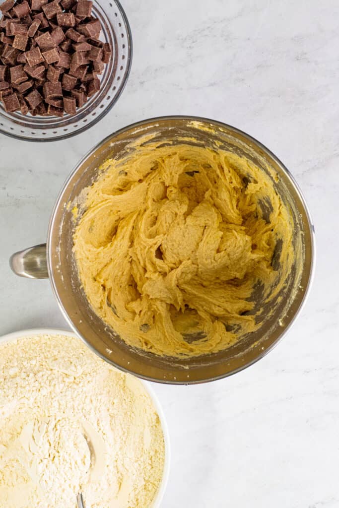 Mixing bowl showing cookie dough after the egg has been mixed in, smooth and light in texture.