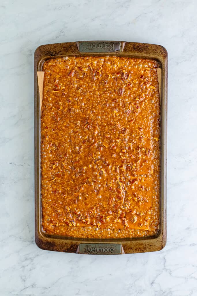 baked caramel and pecan covered graham crackers fresh from the oven on a baking sheet