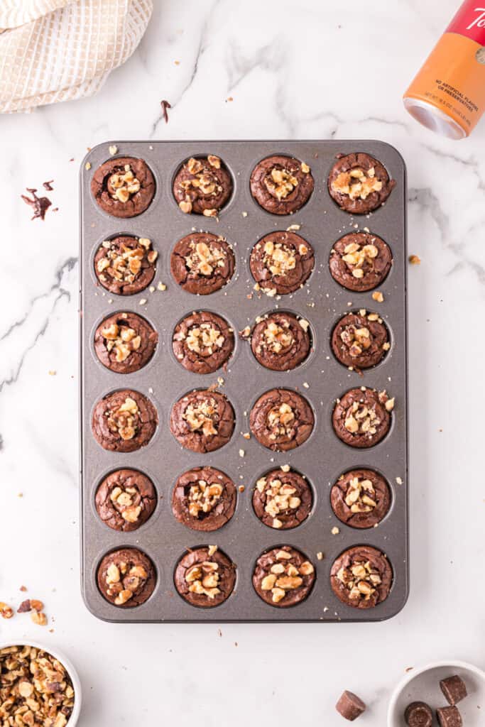 Brownie bites in the mini muffin pan topped with chopped walnuts while still warm.