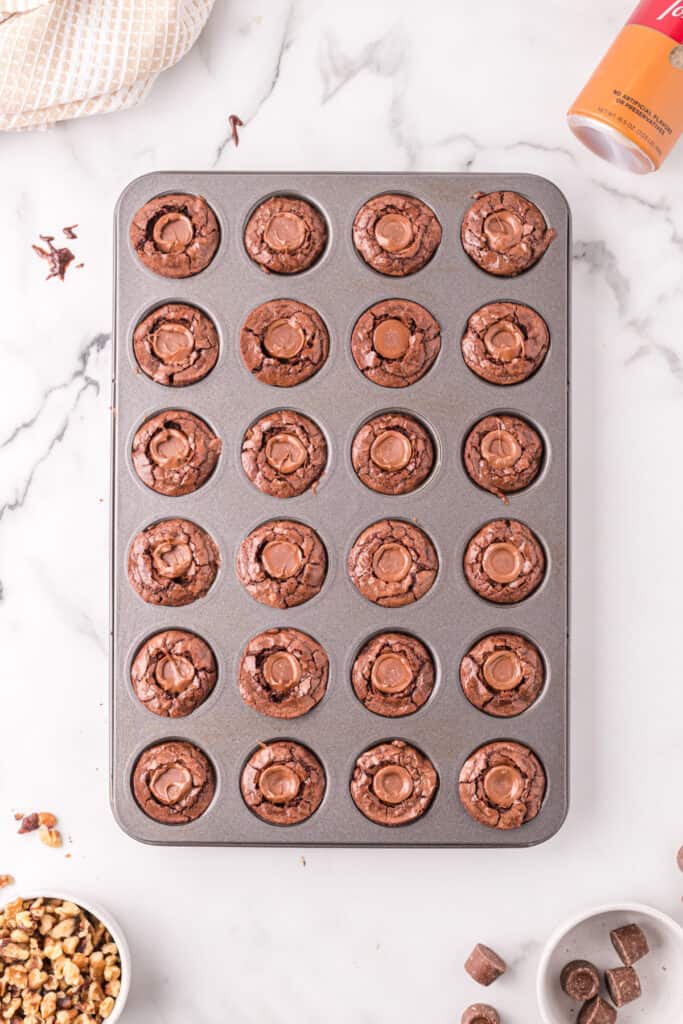 Warm brownie bites in the pan with a Rolo candy pressed into the center of each one.