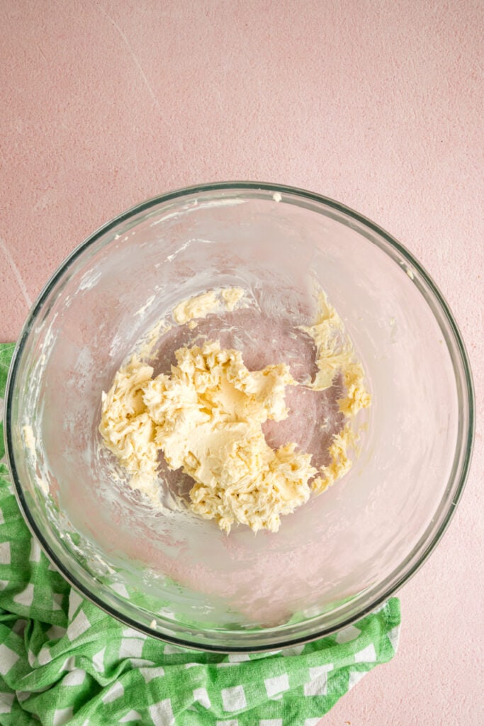 softened butter mixed with vanilla extract in a glass mixing bowl