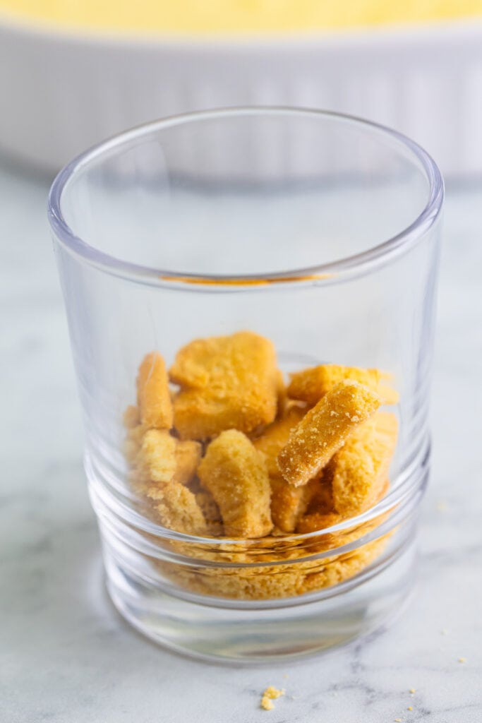 shortbread cookie pieces layered in the bottom of a clear dessert glass
