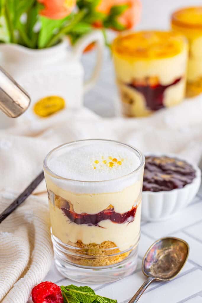 creme brulee trifle with caramelized sugar topping in a clear glass