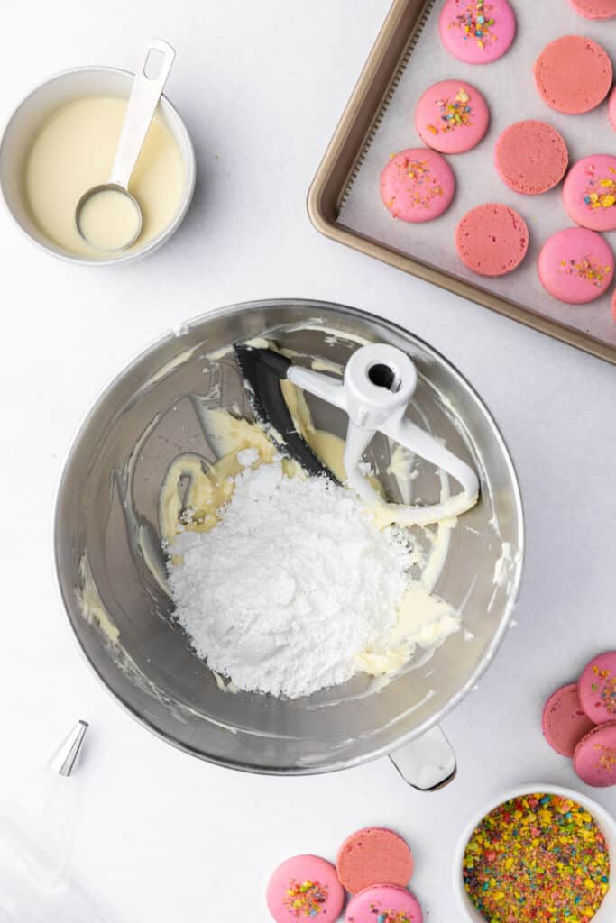 powdered sugar added to buttercream in a stand mixer bowl