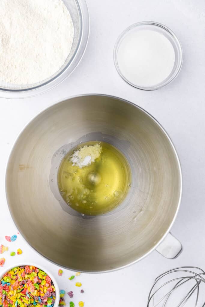Egg whites and cream of tartar added to a stand mixer bowl before whipping
