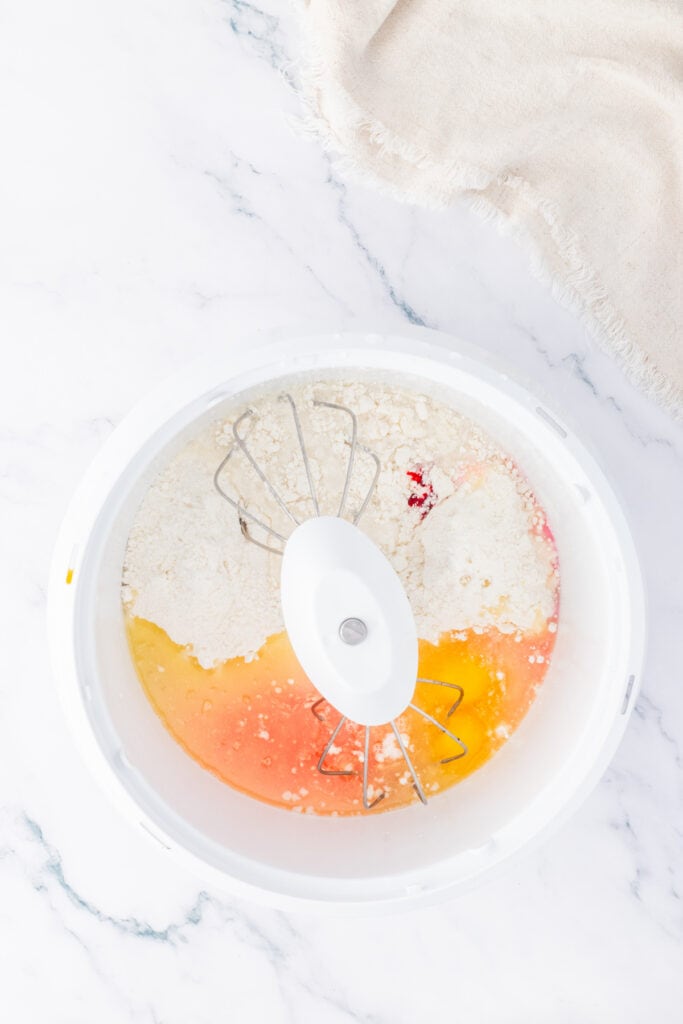 Cake batter ingredients in a mixing bowl before being combined