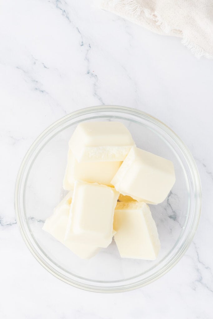 Vanilla candy coating pieces in a glass bowl ready to be melted