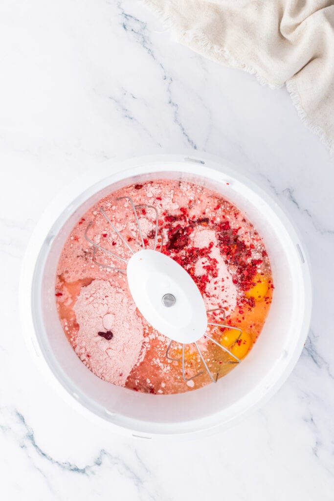 Strawberry cake batter ingredients mixed in a bowl before baking