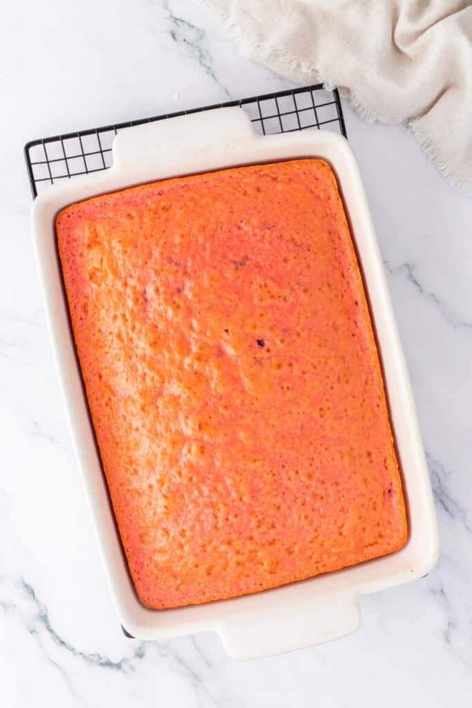 Freshly baked strawberry cake cooling in a rectangular baking dish