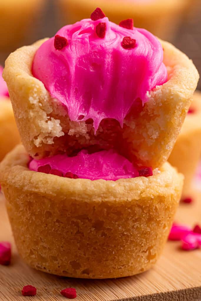 Valentine sugar cookie cup broken open showing soft cookie texture and pink frosting inside
