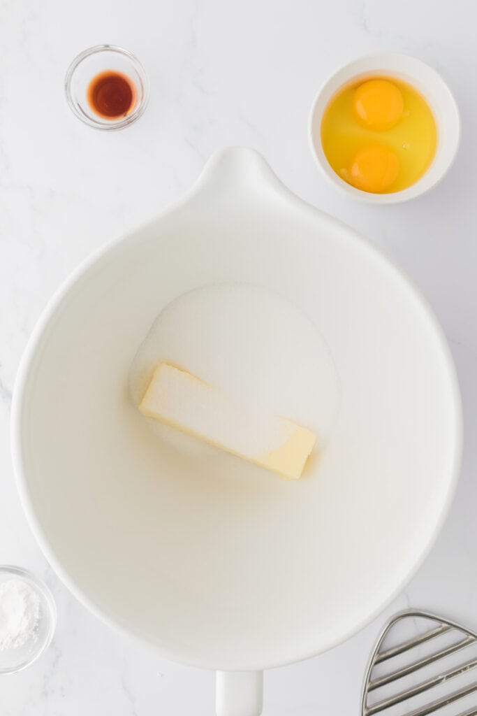 Butter and sugar combined in a large white mixing bowl before creaming
