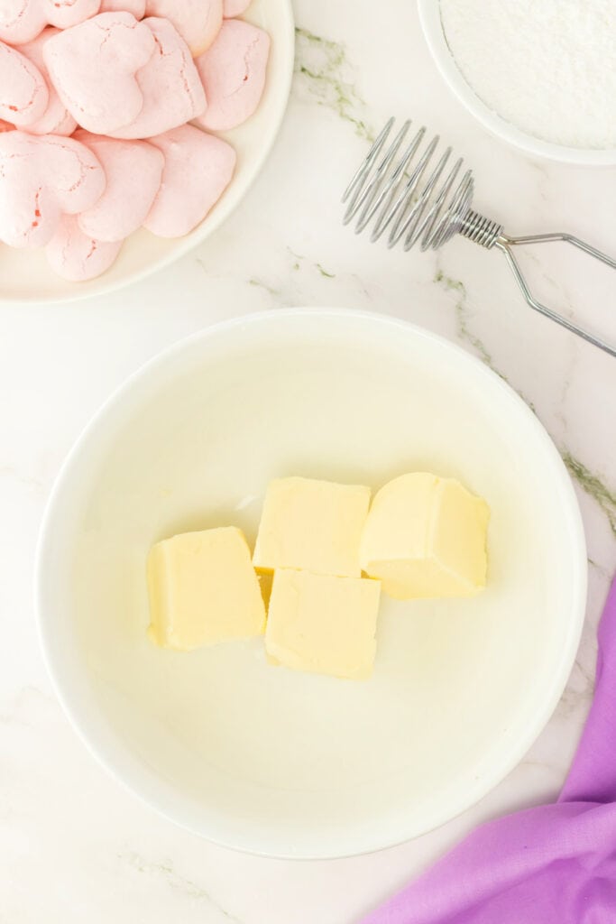 bowl of softened butter cut into cubes for making vanilla buttercream filling