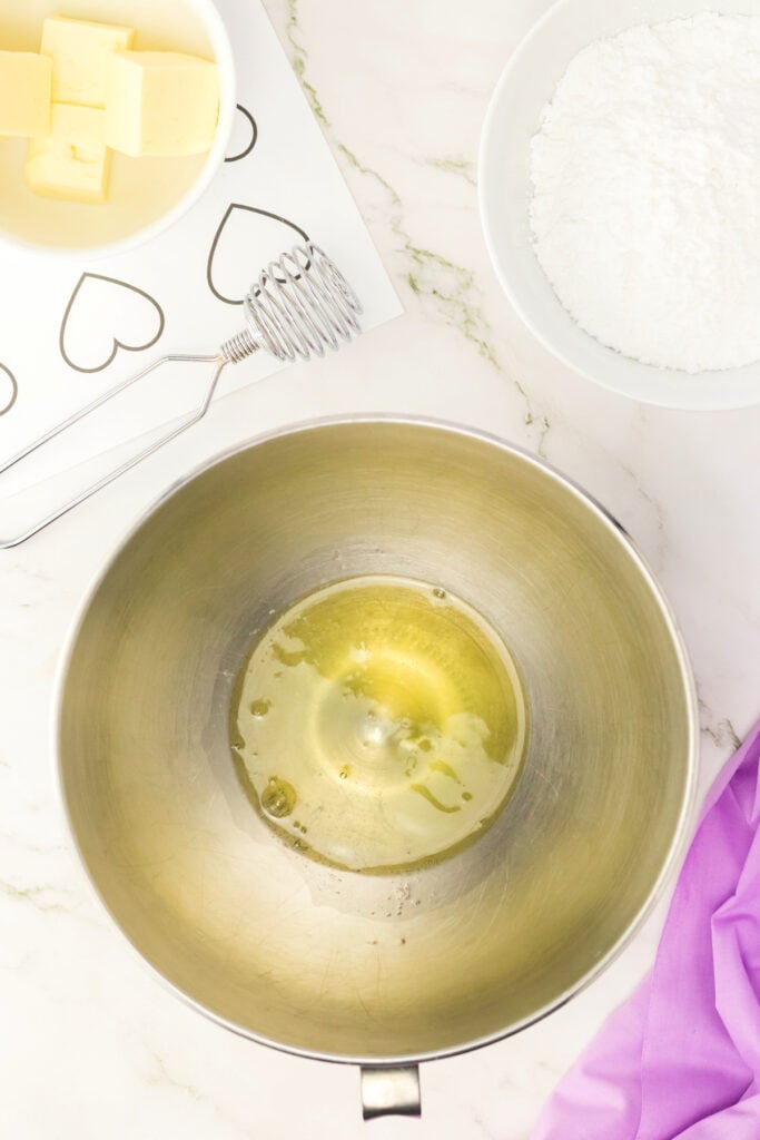 egg whites in a metal mixing bowl before whipping into meringue