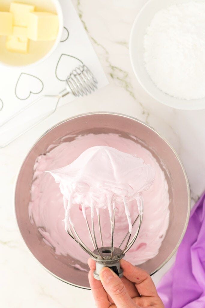 pale pink macaron batter whipped to stiff peaks on a whisk attachment