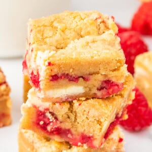 Stacked white chocolate raspberry blondies showing thick layers of white chocolate and fresh raspberries