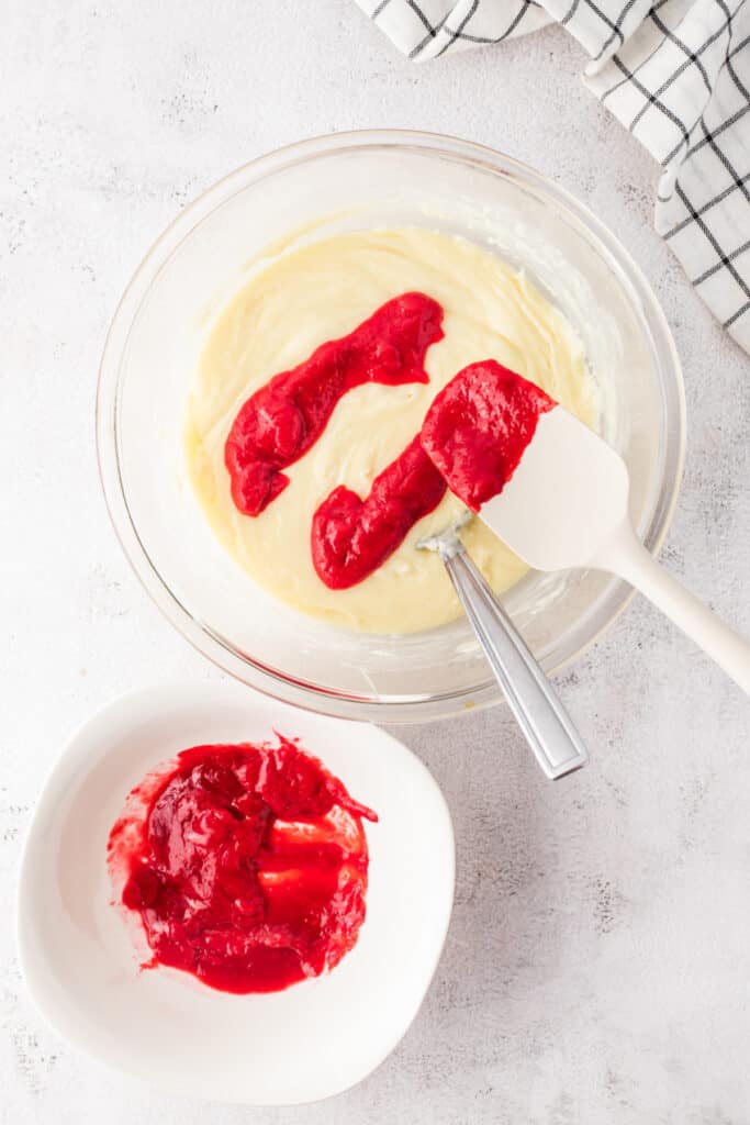 Raspberry puree added to melted white chocolate mixture