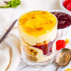 finished creme brulee trifle with layered custard, shortbread cookies, raspberry jam, and a crackly caramelized sugar top